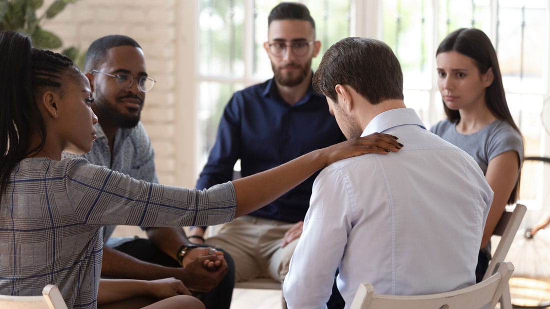 individuals supporting each other in free support group