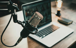 podcasting equipment on a wooden desk